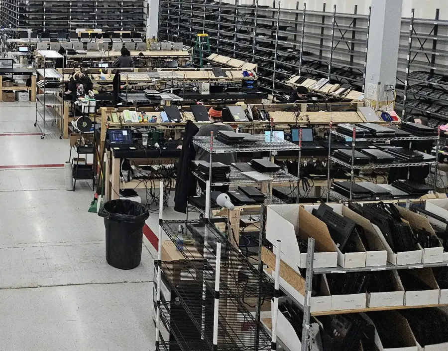 Benches and carts of laptops on the refurbishing floor at Regadget’s facility in Florence, Kentucky.