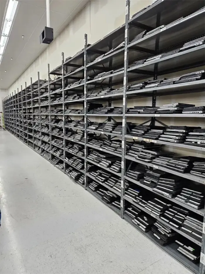 Shelves of refurbished laptops, stacked and labelled, on Regadget’s floor.